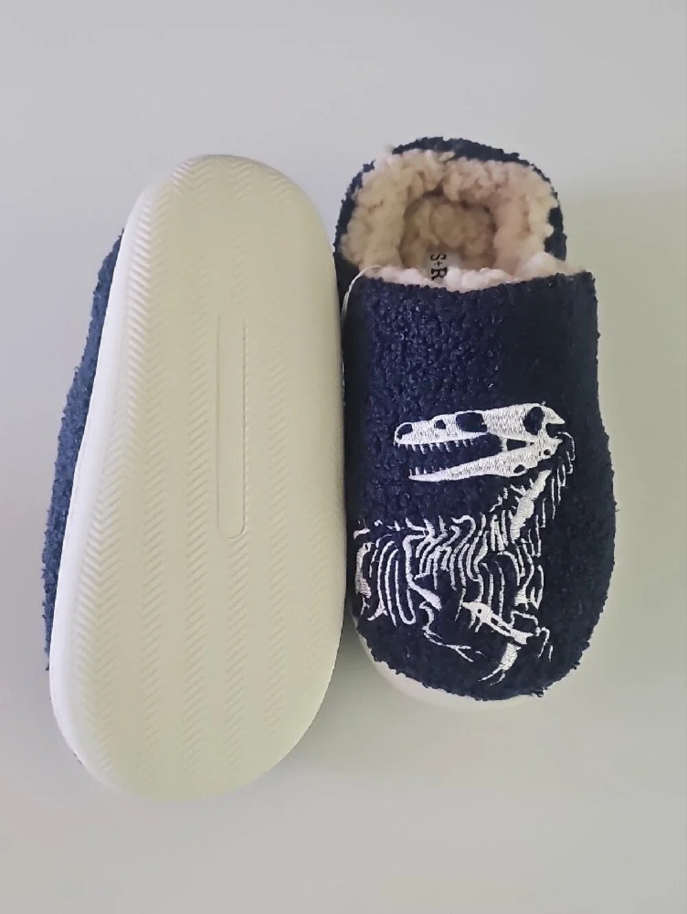 Navy Fuzzy Slippers with White Dinosaur Skeleton